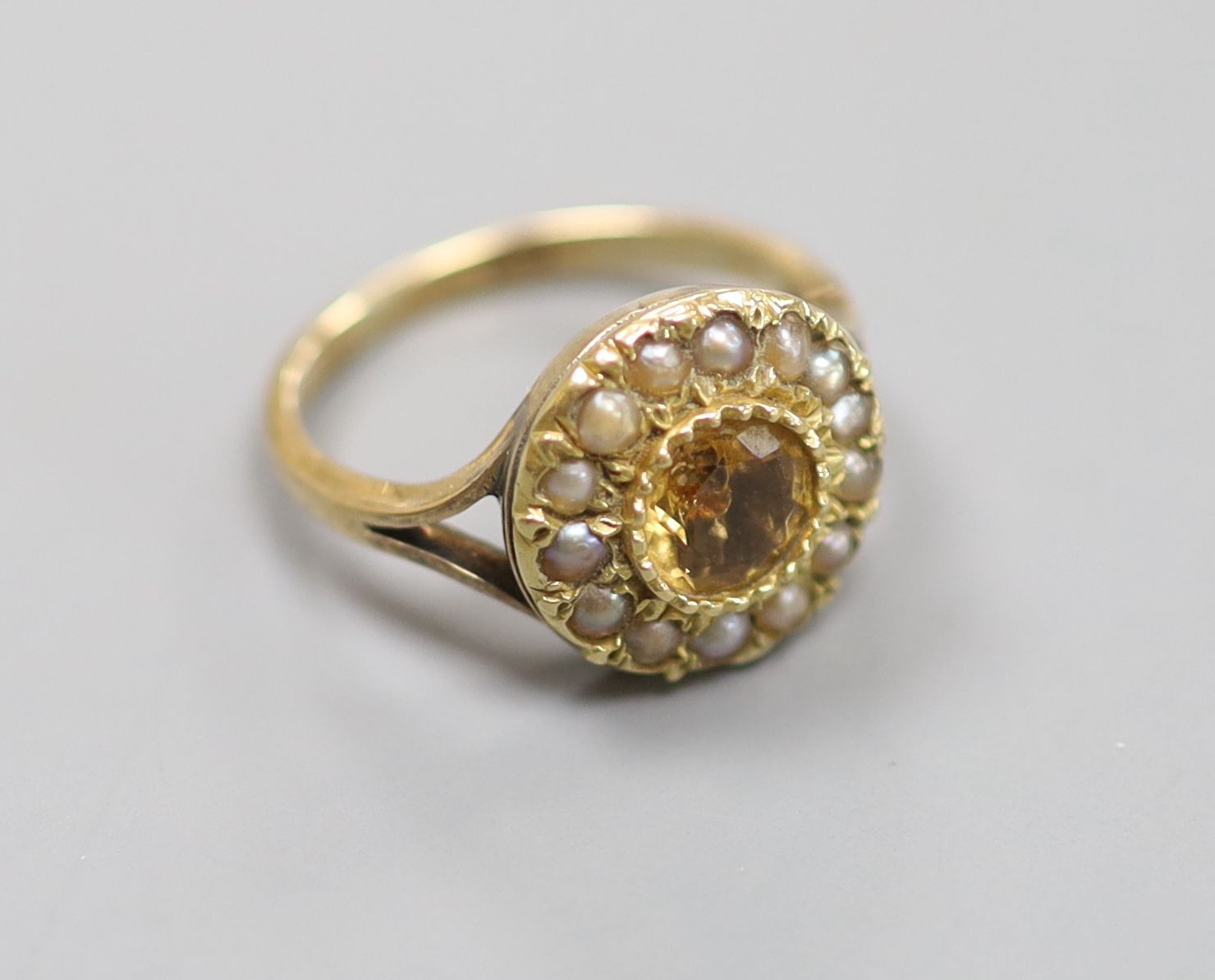 A 9ct, citrine and seed pearl set circular cluster ring